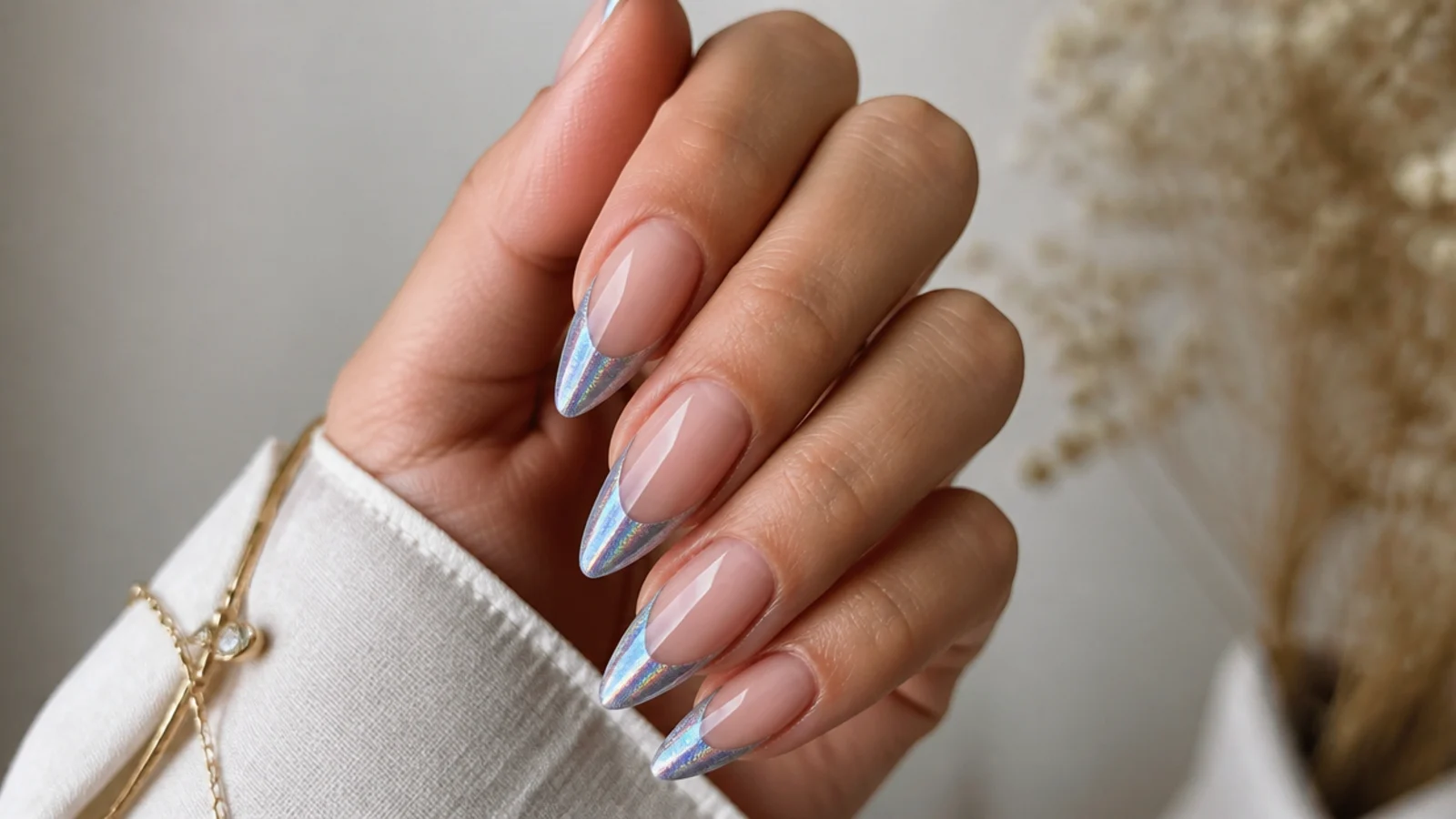 Almond nails with a holographic chrome magnetic cat eye french tip