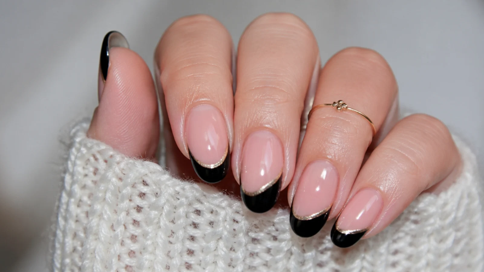 Black french tip nails with a curved cat eye stripe following the smile line