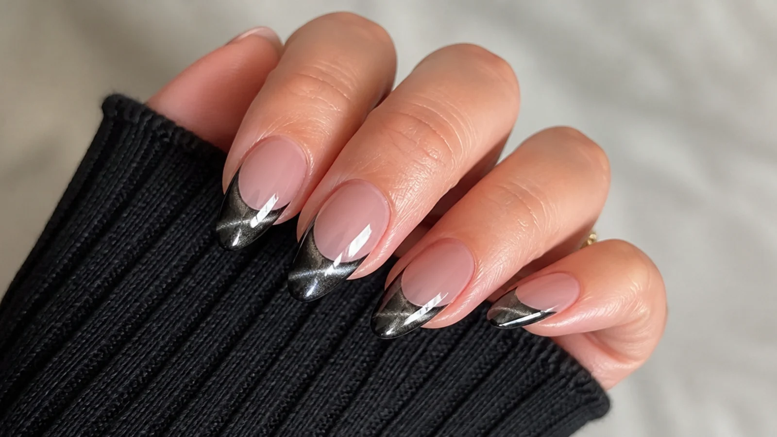 Black chrome cat eye french tip nails with a mirror-bright stripe