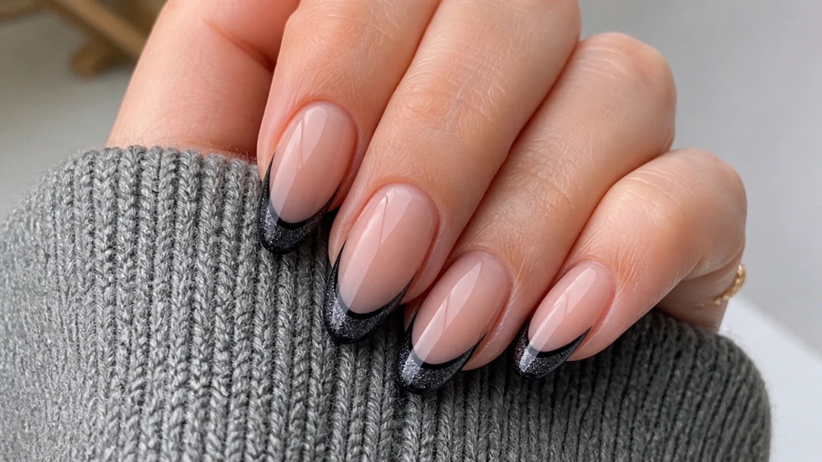 Black cat eye french tip nails with fine silver glitter in the tip