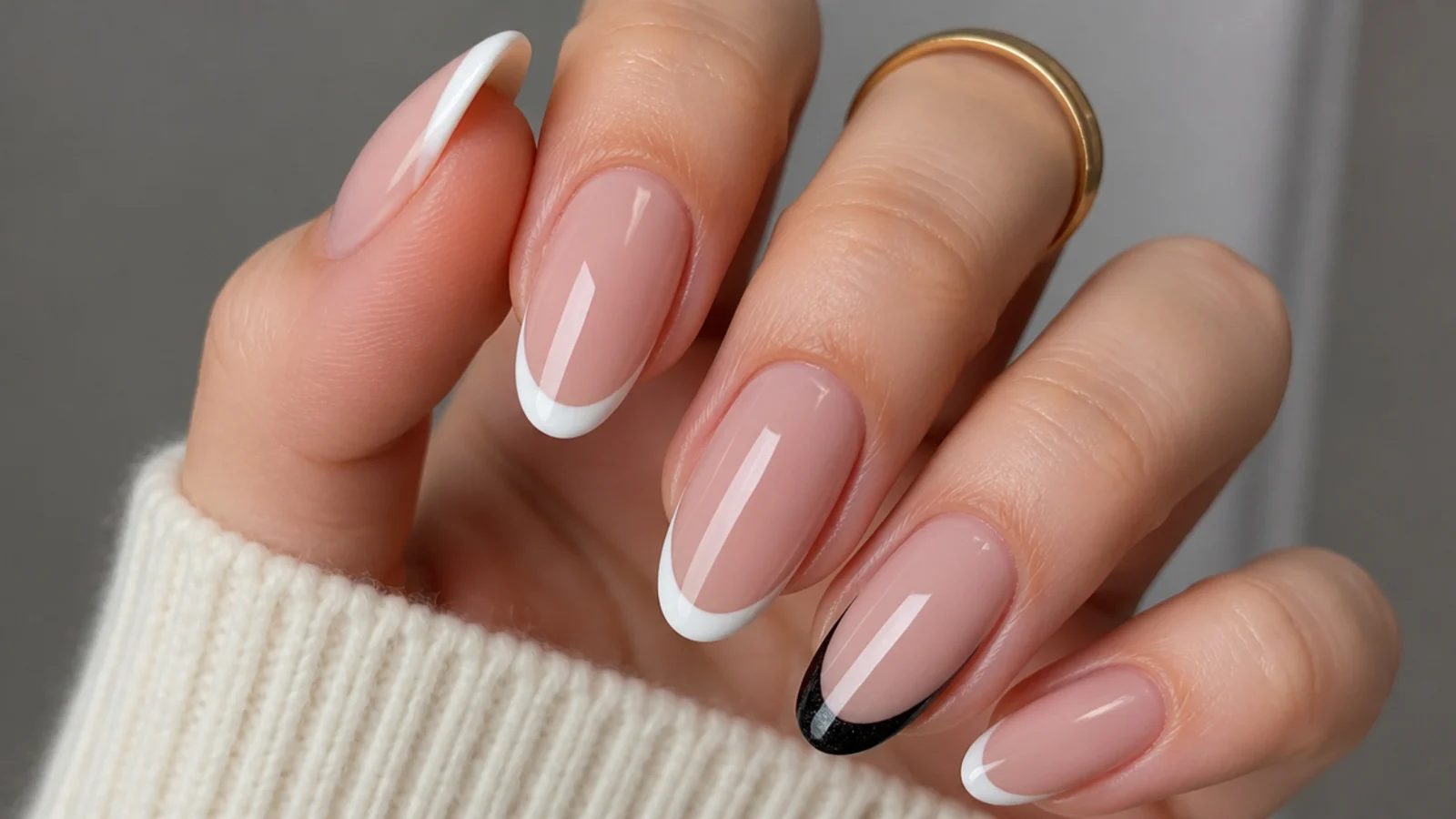 Nude french nails with one black cat eye french tip accent nail