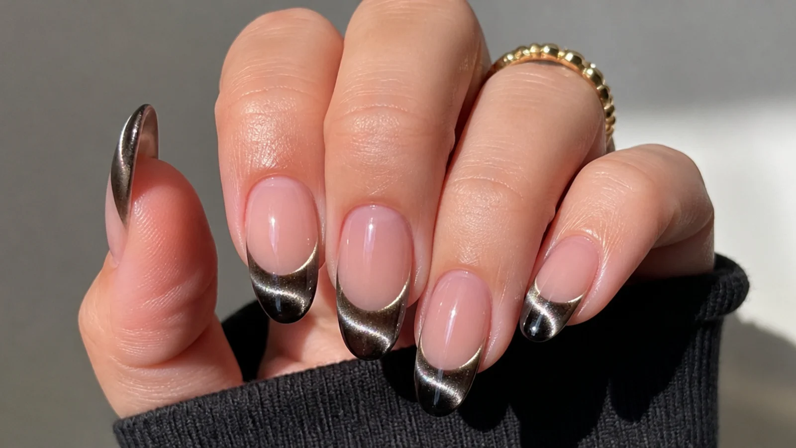 Black cat eye french tip nails with a bright 3D light stripe across each almond tip