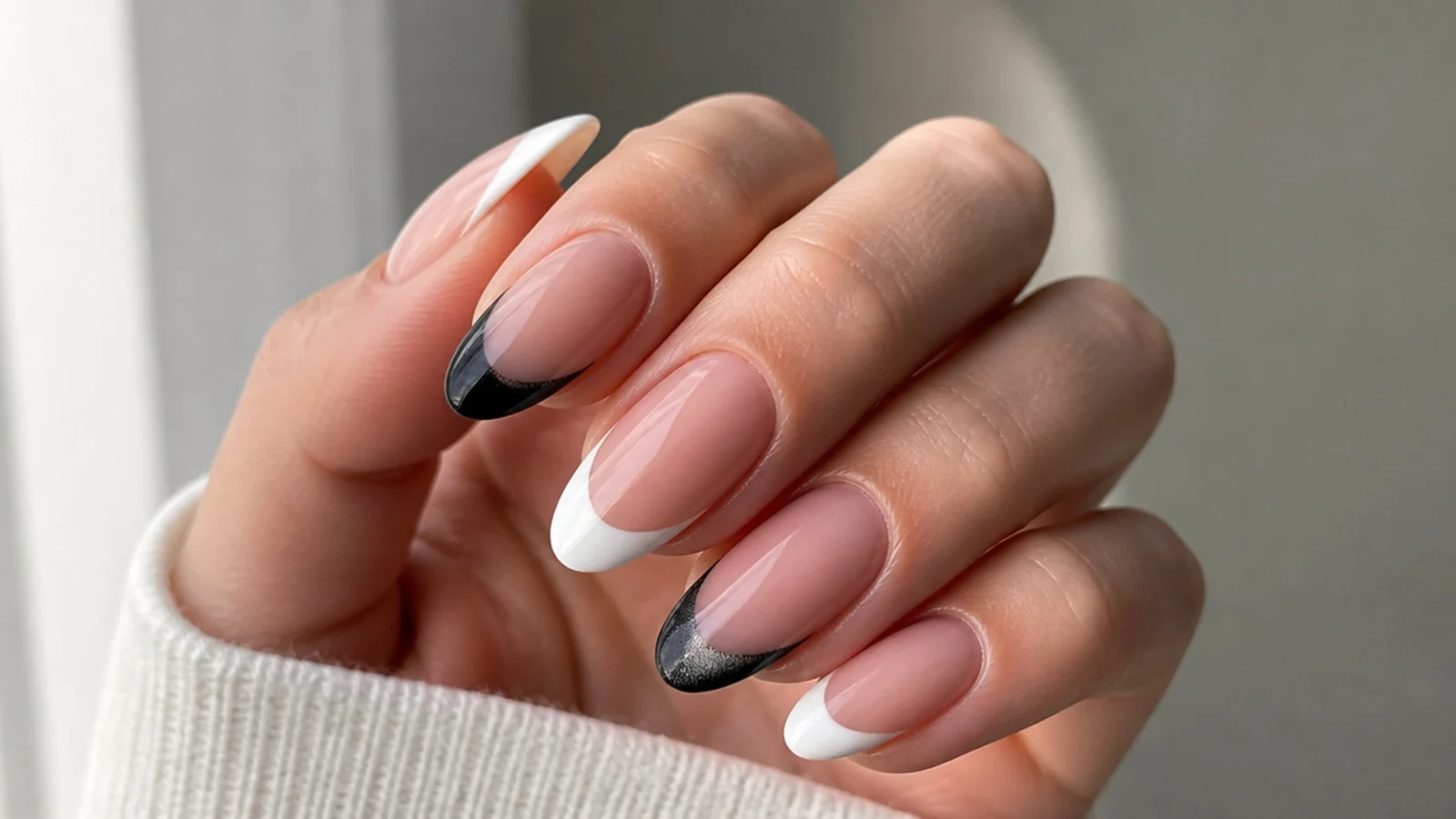 A black cat eye french tip beside a flat white classic french tip