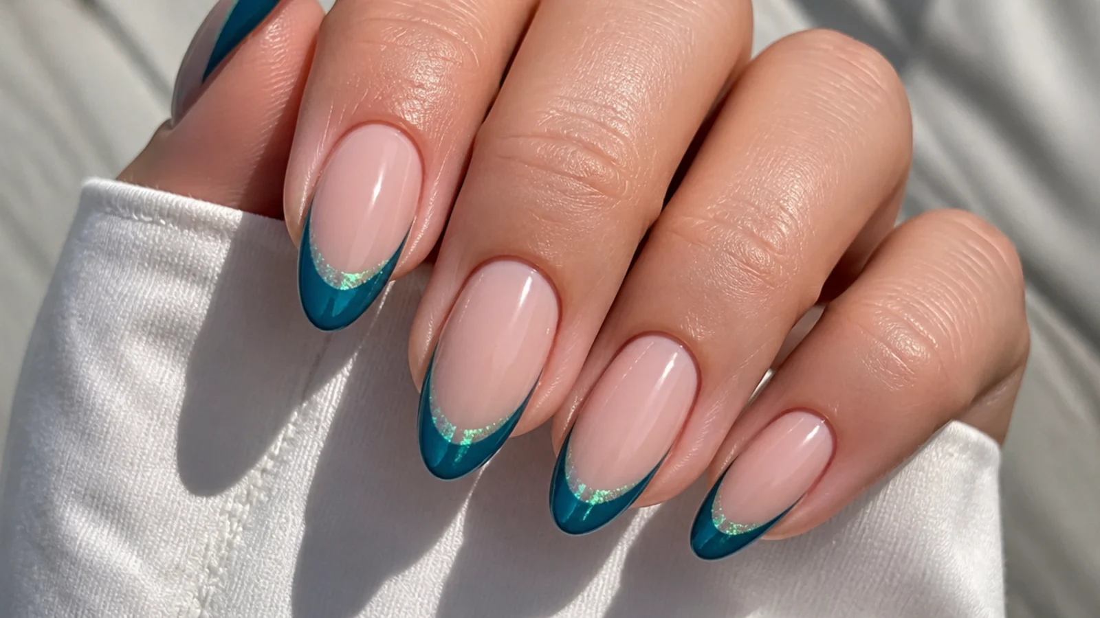Blue teal cat eye french tip nails with a green-blue shifting light stripe