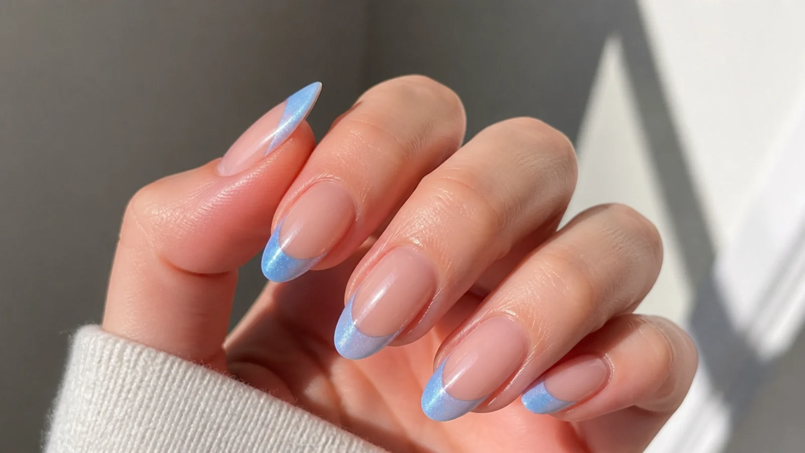 Light sky blue cat eye french tips with a soft airy light stripe