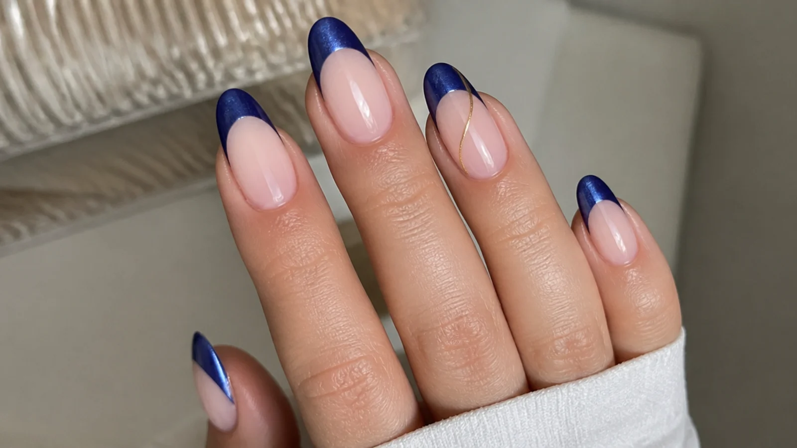 Cobalt blue cat eye french tips with a thin gold line on one accent nail