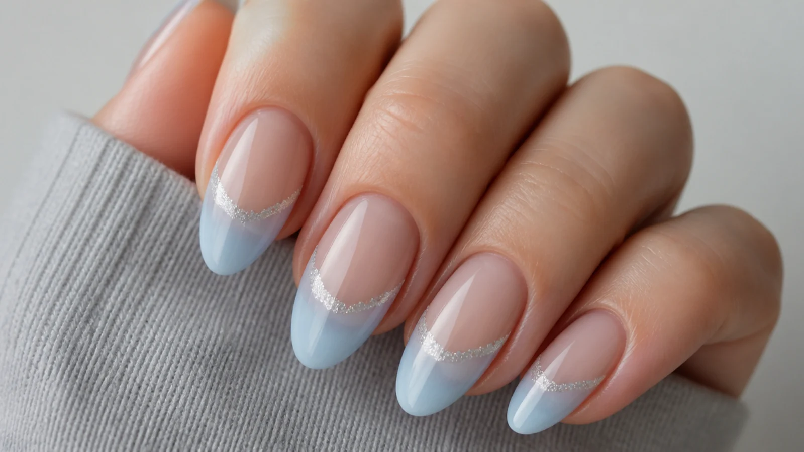 Frosted pale blue cat eye french tips with a shimmery snow-like stripe