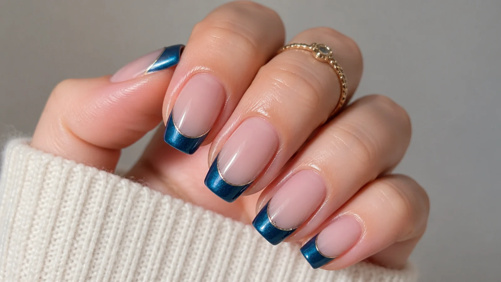A well-sealed blue cat eye french tip manicure with cuticle oil for longevity