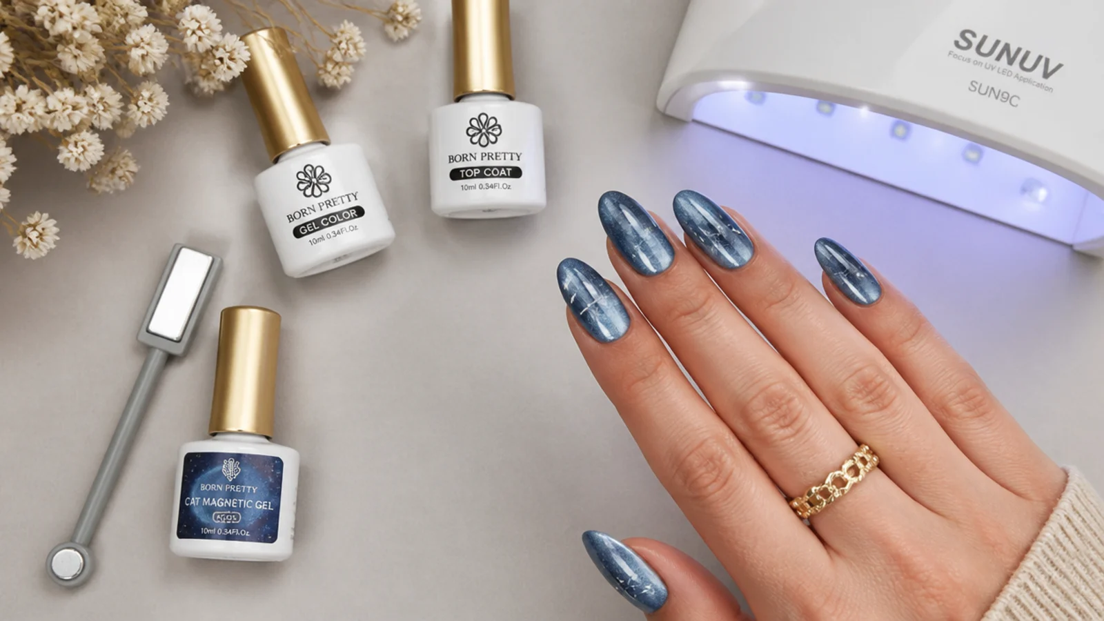 Flat lay of blue cat eye gel, a magnet, a lamp, base and top coat