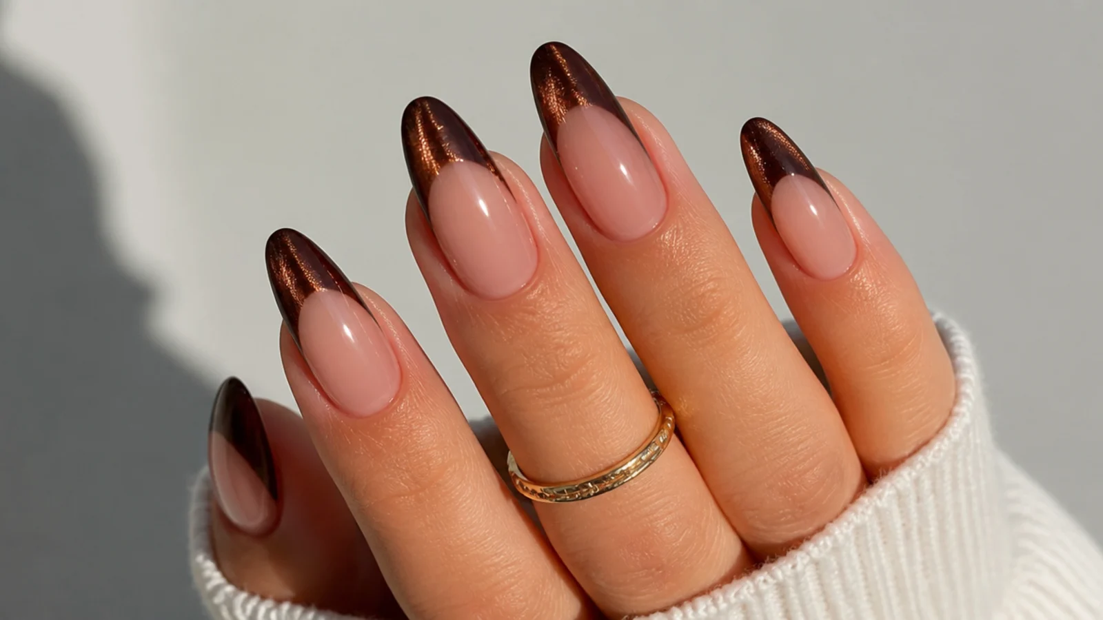 Rich chocolate brown cat eye french tips on long almond nails