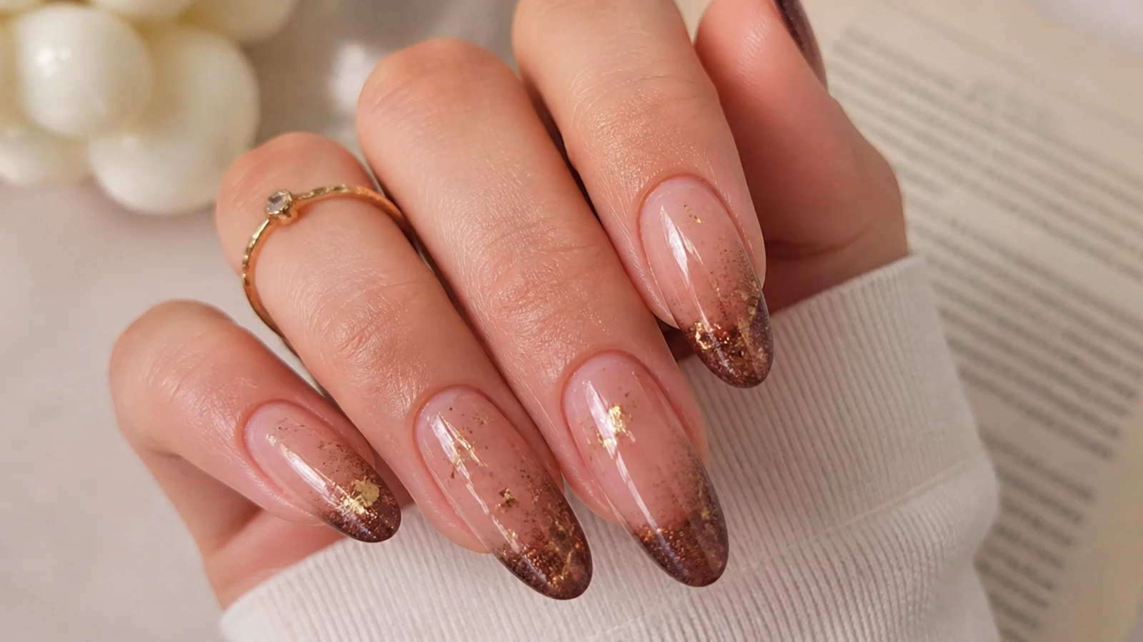 Mocha cat eye french tip nails with scattered gold flakes