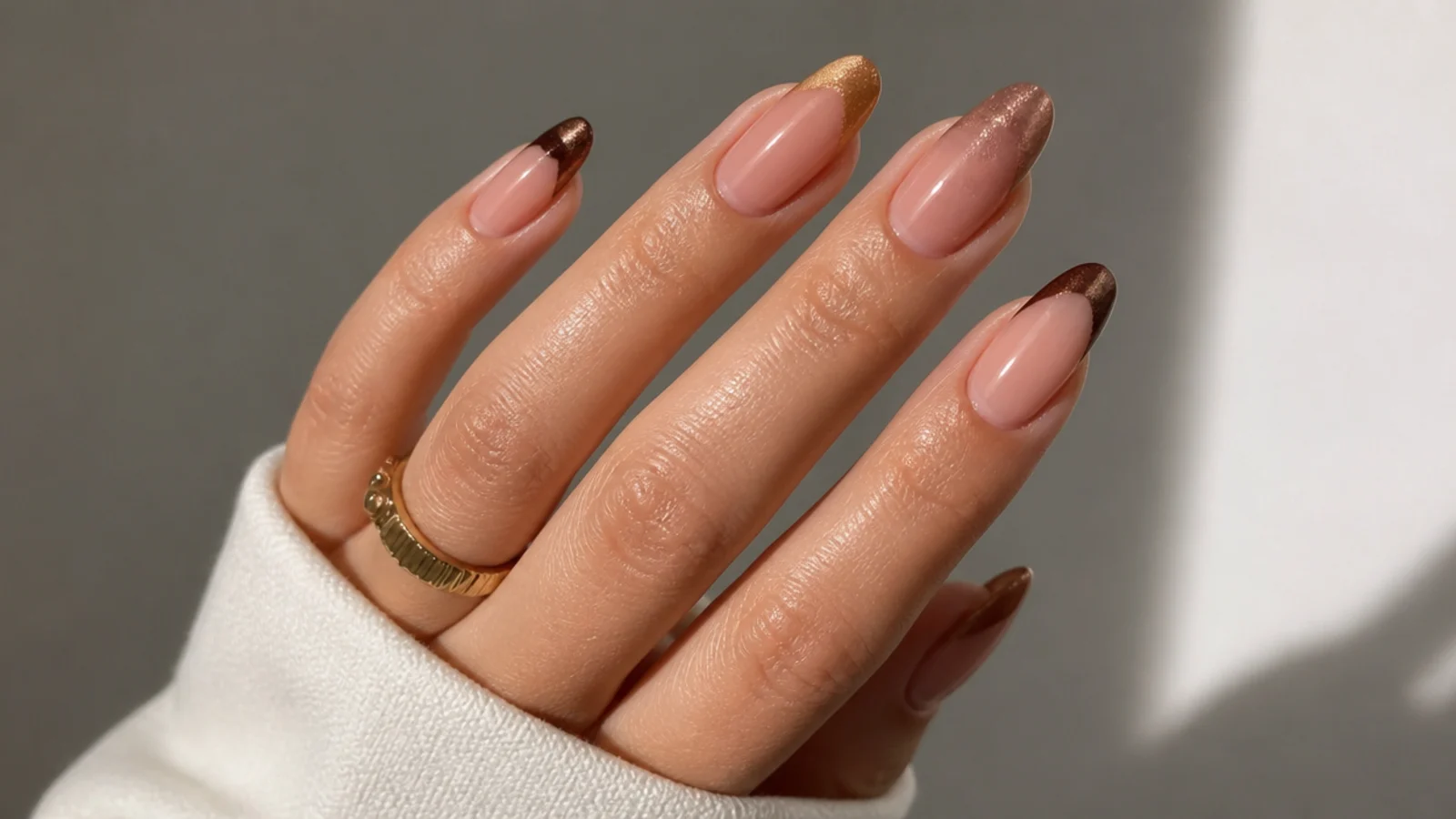 Two-tone caramel and espresso cat eye french tips across the hand