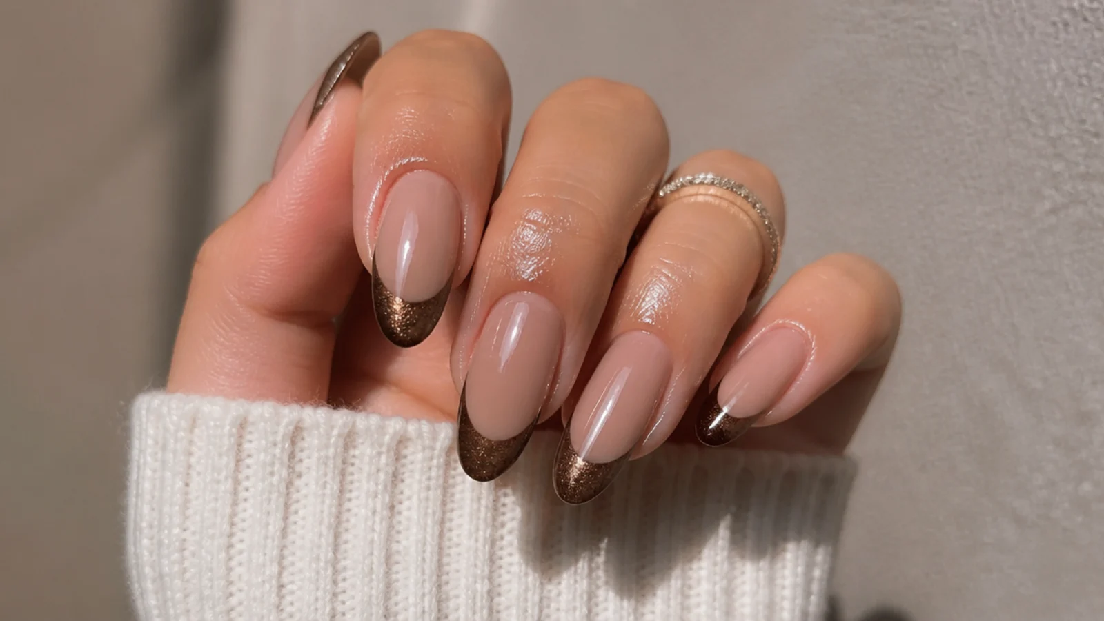 A well-sealed brown cat eye french manicure with cuticle oil for longevity
