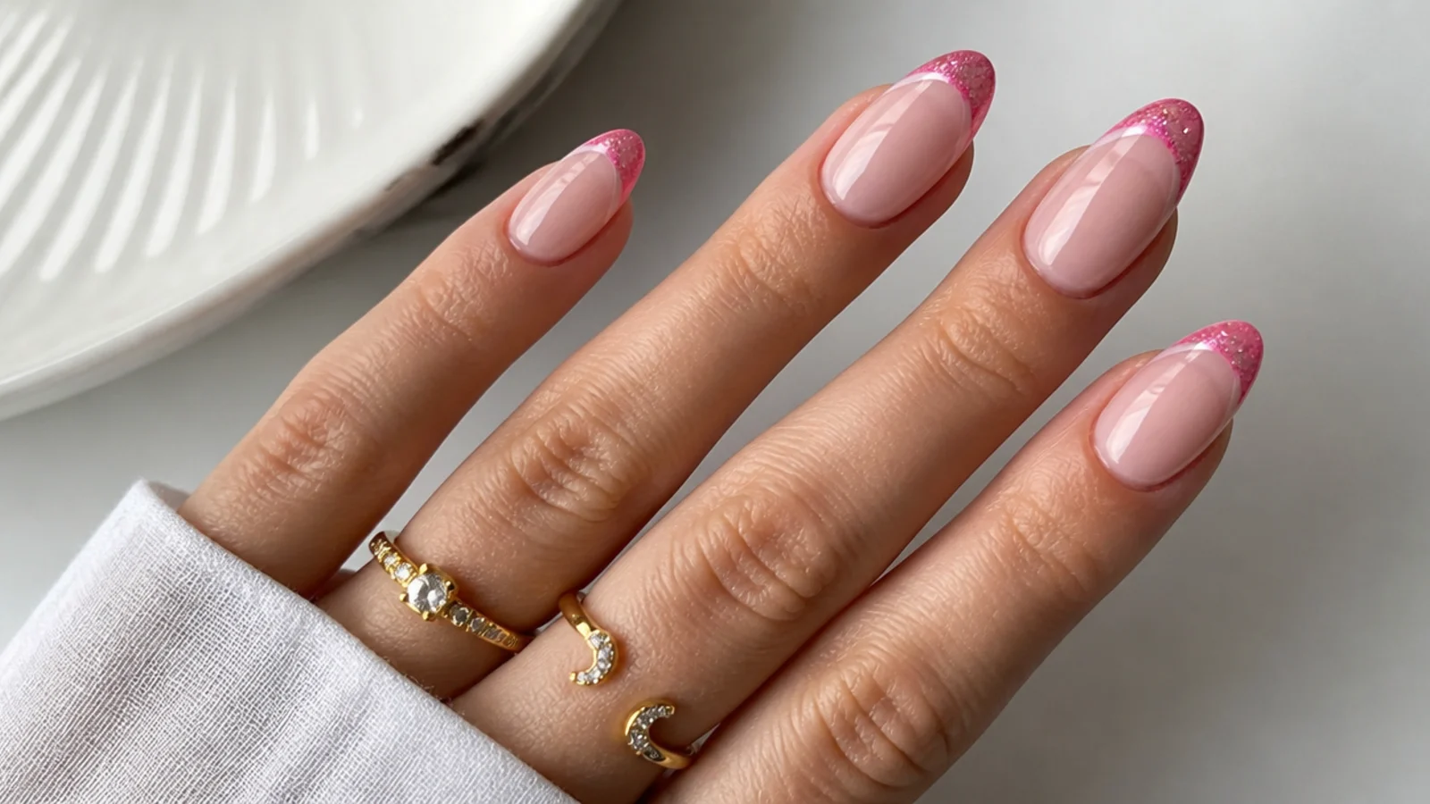 Milky base nails with a bright bubblegum pink magnetic cat eye french tip