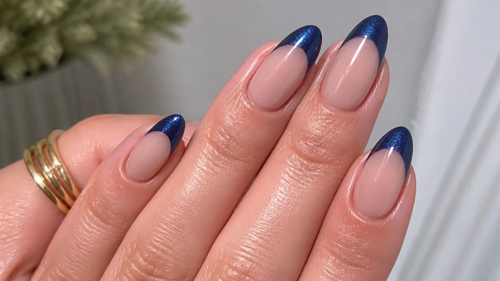 Sheer base nails with a deep cobalt blue magnetic cat eye french tip