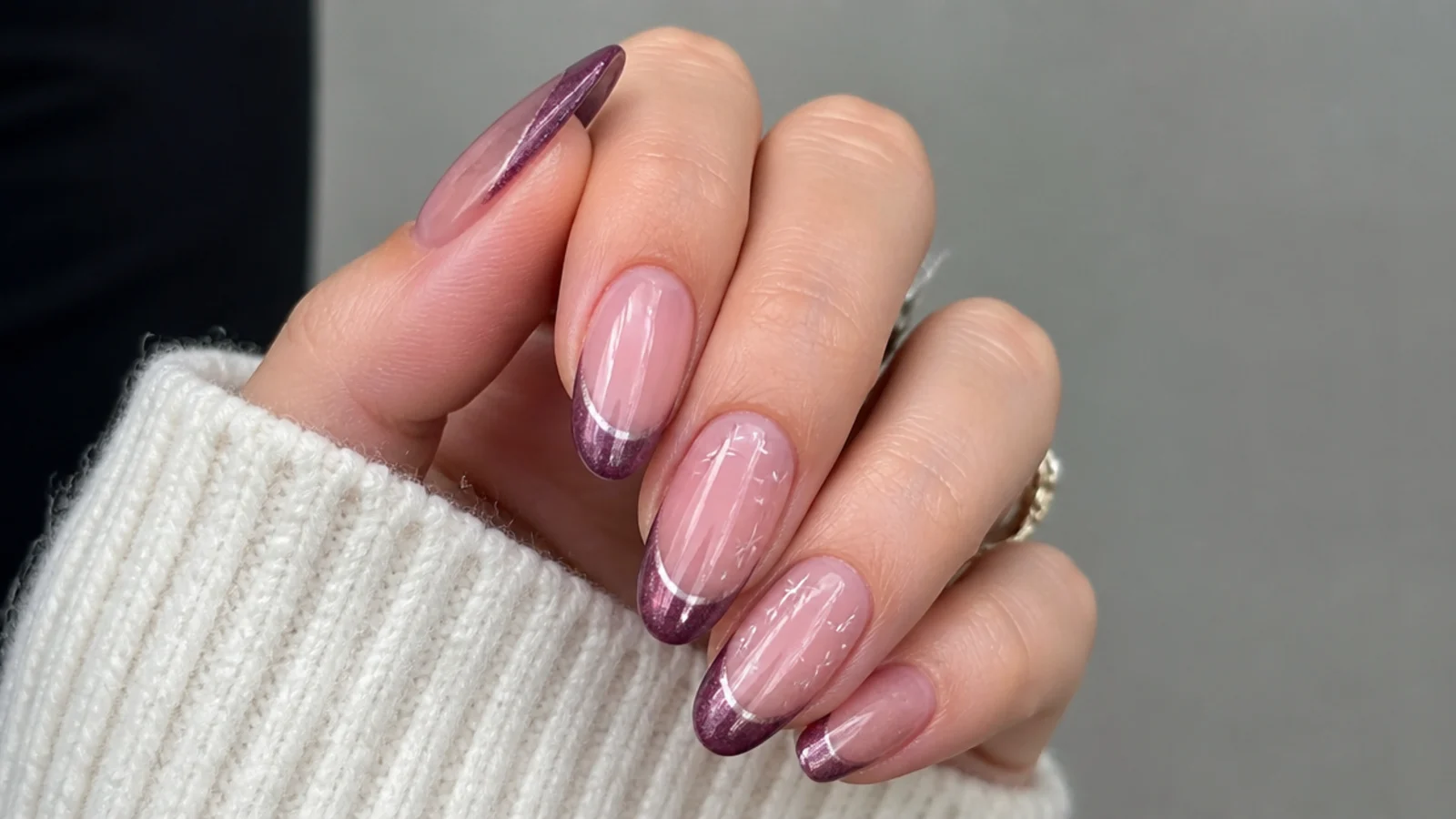 Sheer nails with a deep plum purple magnetic cat eye french tip