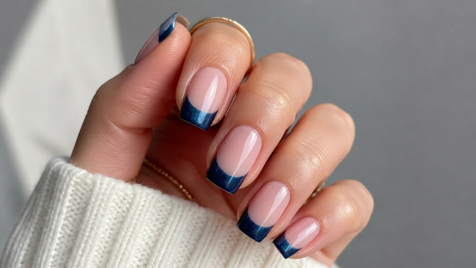 Square nails with a nude base and a deep midnight navy magnetic cat eye tip
