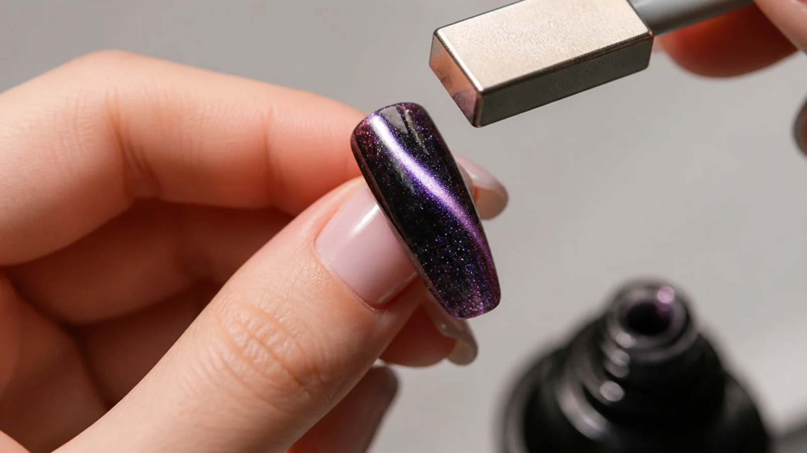 A magnet held above a wet magnetic gel tip pulling a bright 3D stripe of light