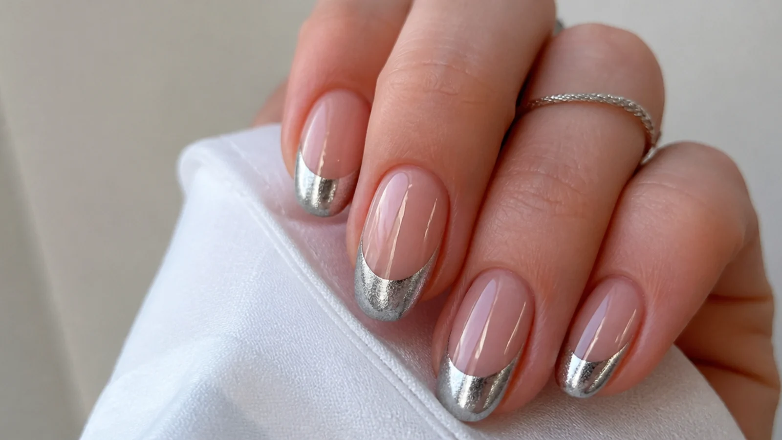 Metallic silver magnetic cat eye french tip nails with a mirror-like light stripe