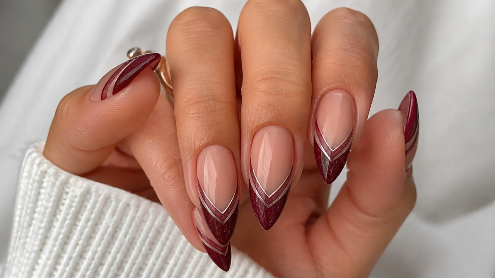 Deep V-shaped magnetic cat eye french tip nails with a light line following the point