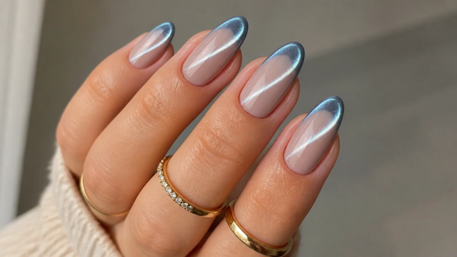 Almond nails with a bright magnetic cat eye stripe glowing along each french tip