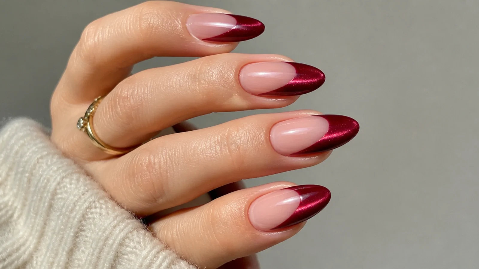 Deep red magnetic cat eye french tip with a bright light stripe on almond nails