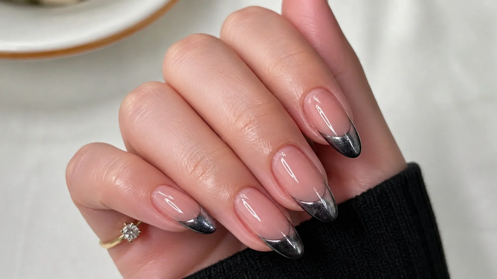 Black magnetic cat eye french tip with a sharp light stripe on almond nails