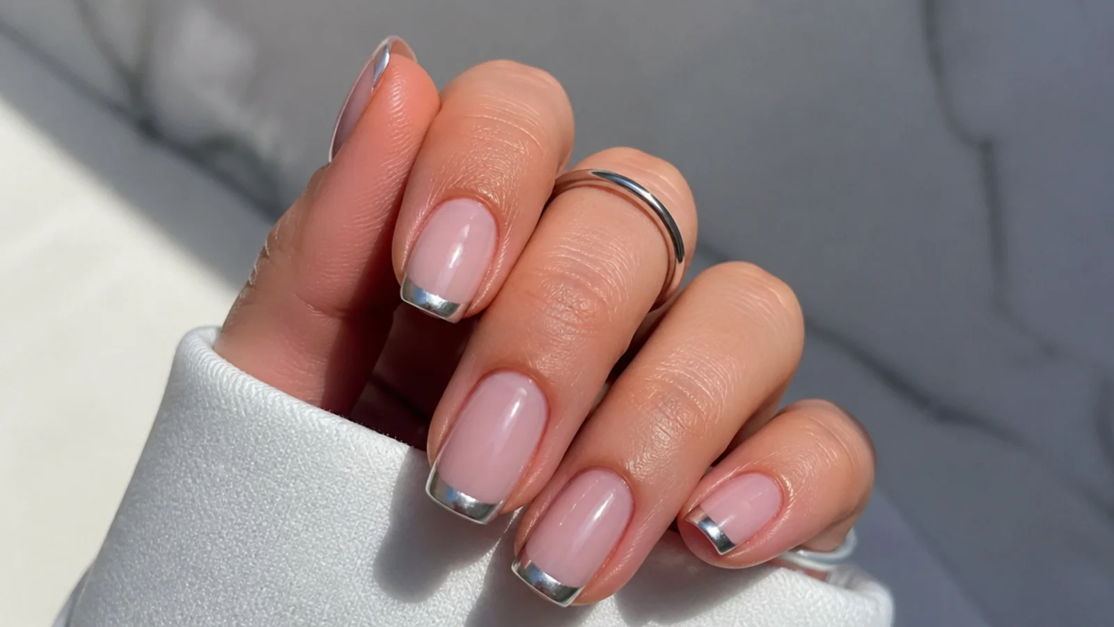 Sheer base with a flat metallic silver french tip on square nails