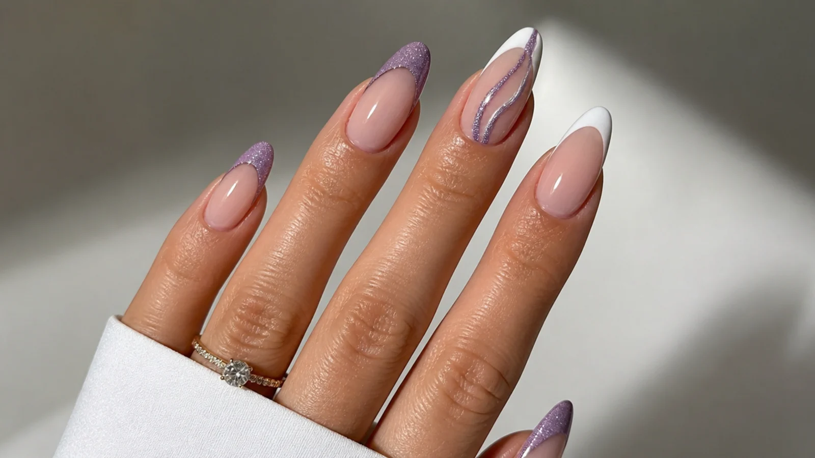 Cat eye magnetic french tip nails with a bright 3D stripe beside a crisp white classic french