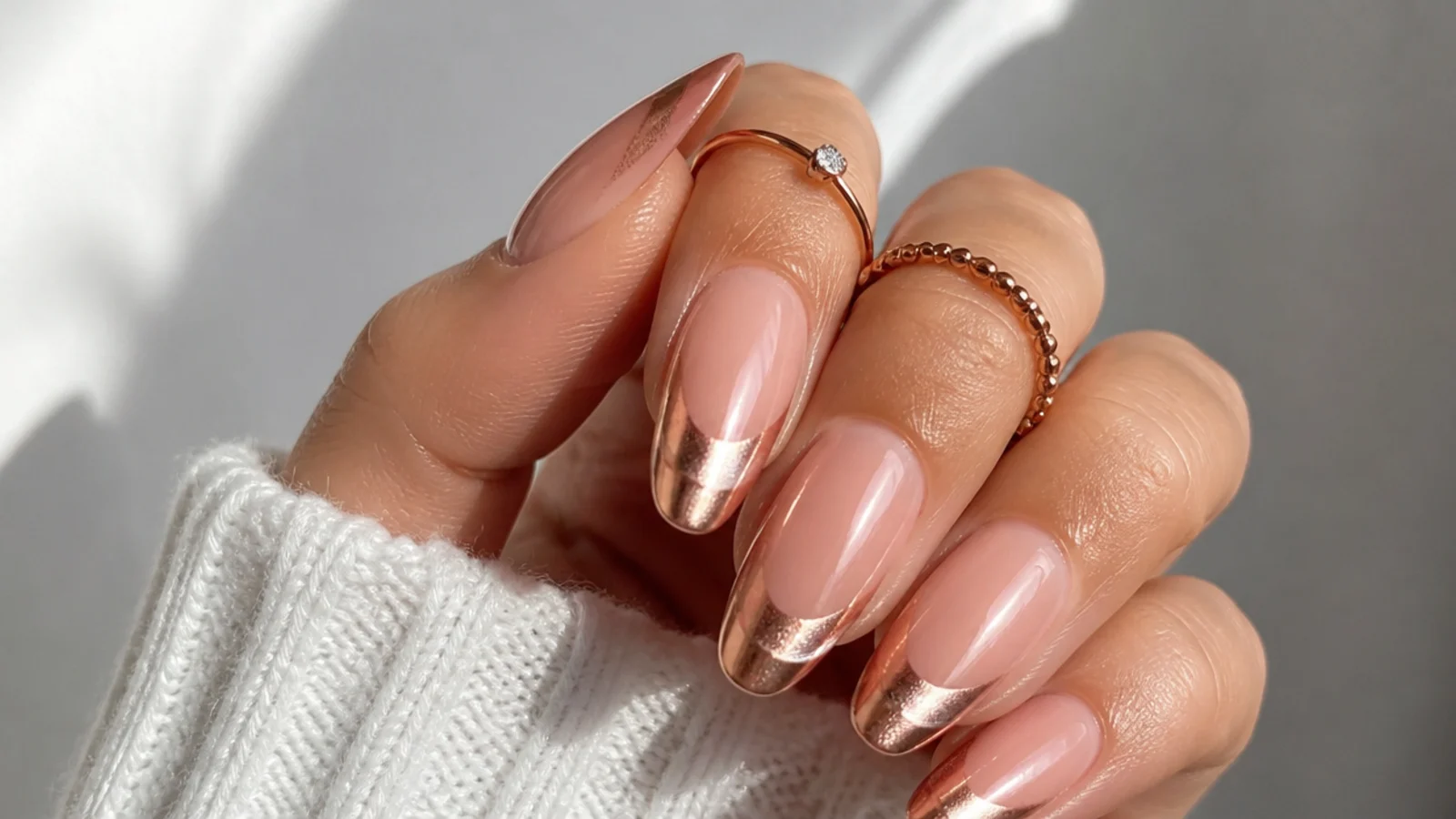 Rose gold chrome cat eye french tip nails on a soft nude base