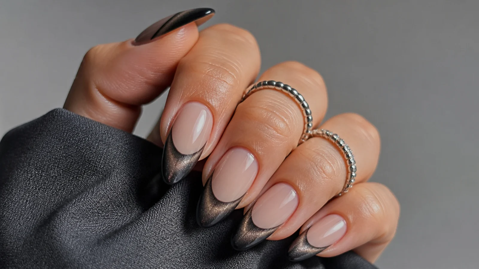 Dark gunmetal gray chrome cat eye french tip nails with a smoky light stripe