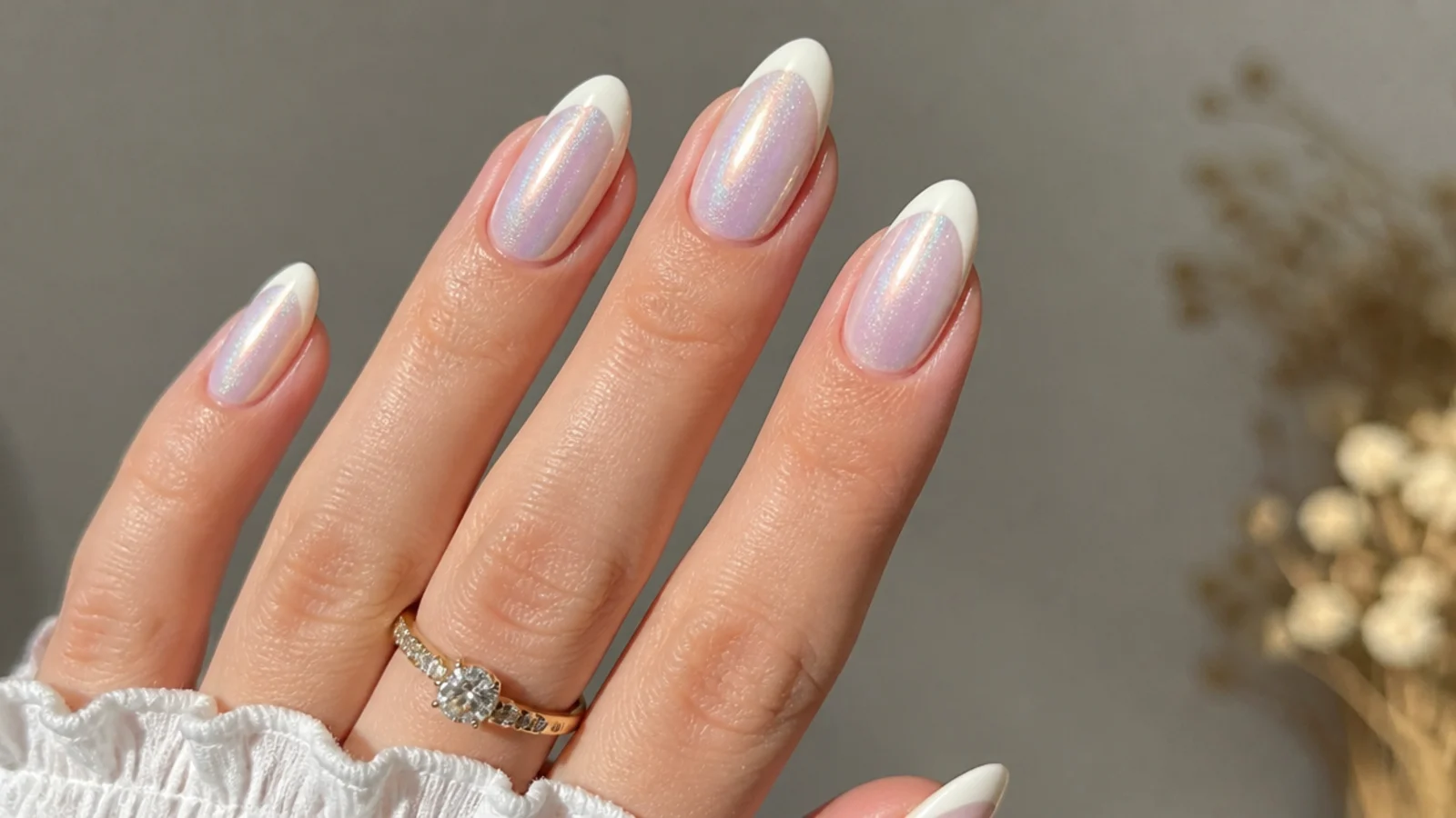 Pearl white chrome cat eye french tip nails with an opal light band