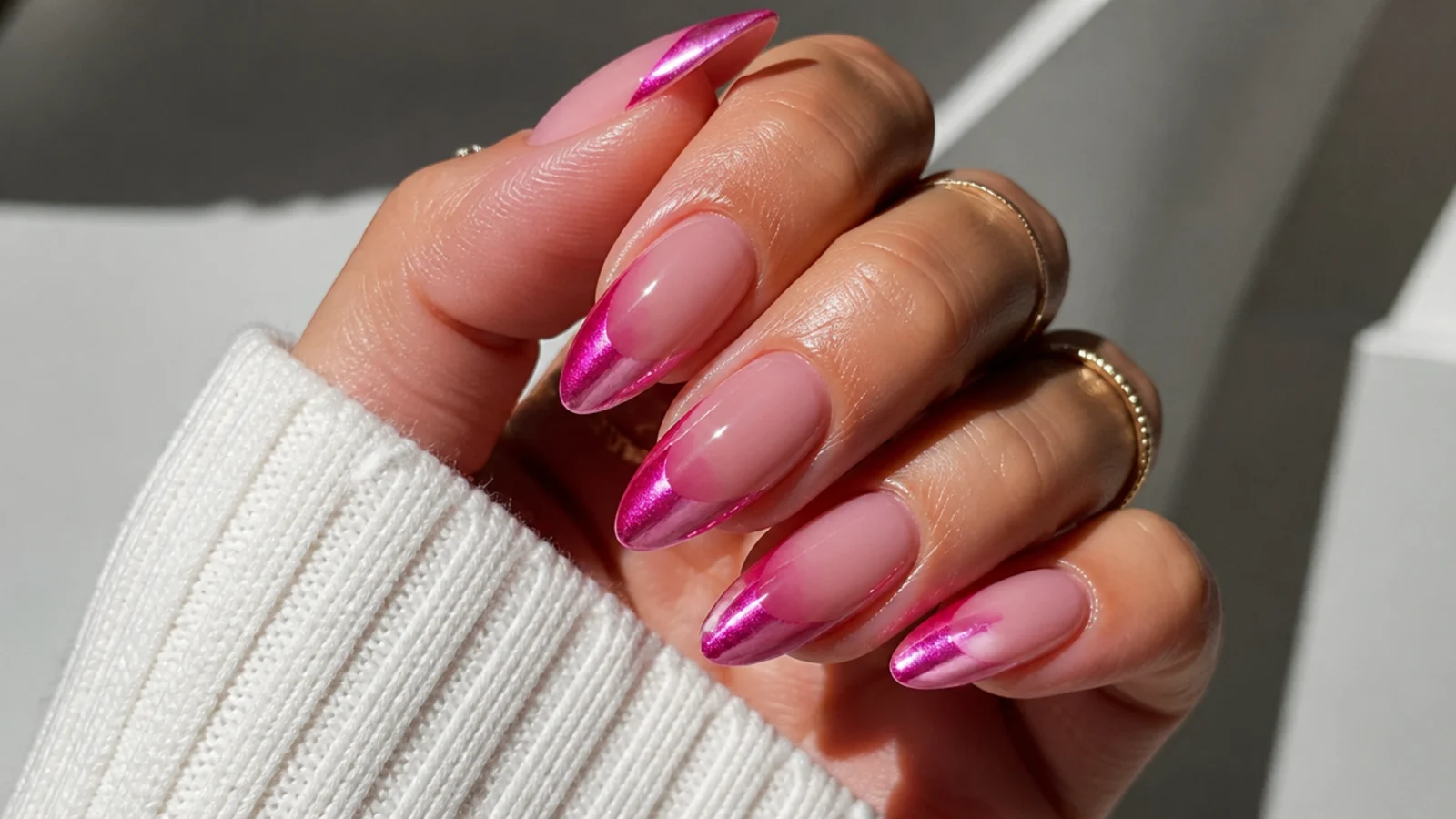 Bright pink chrome cat eye french tip nails with a magenta light stripe