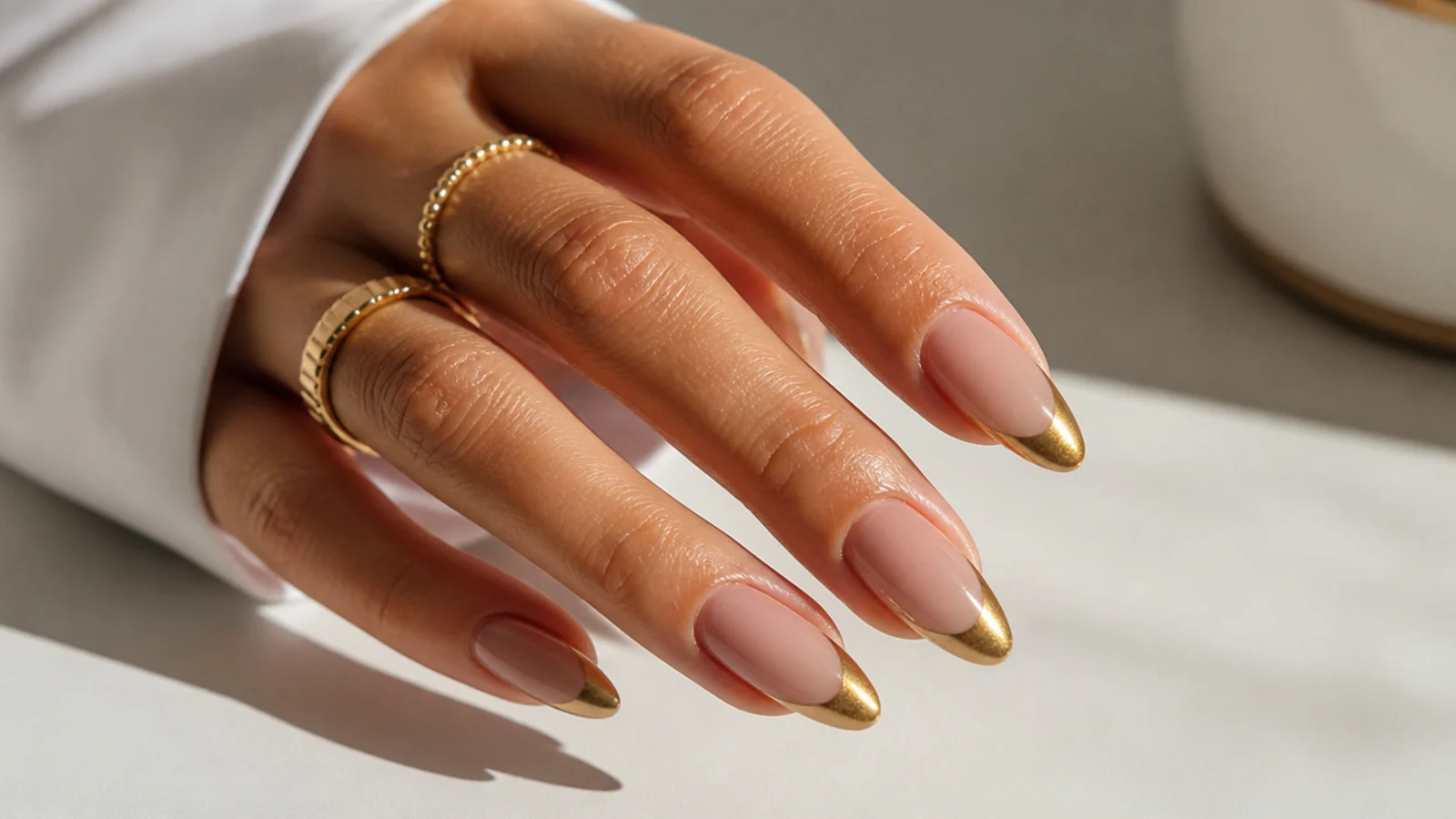 Bright gold chrome cat eye french tip nails on long almond shapes