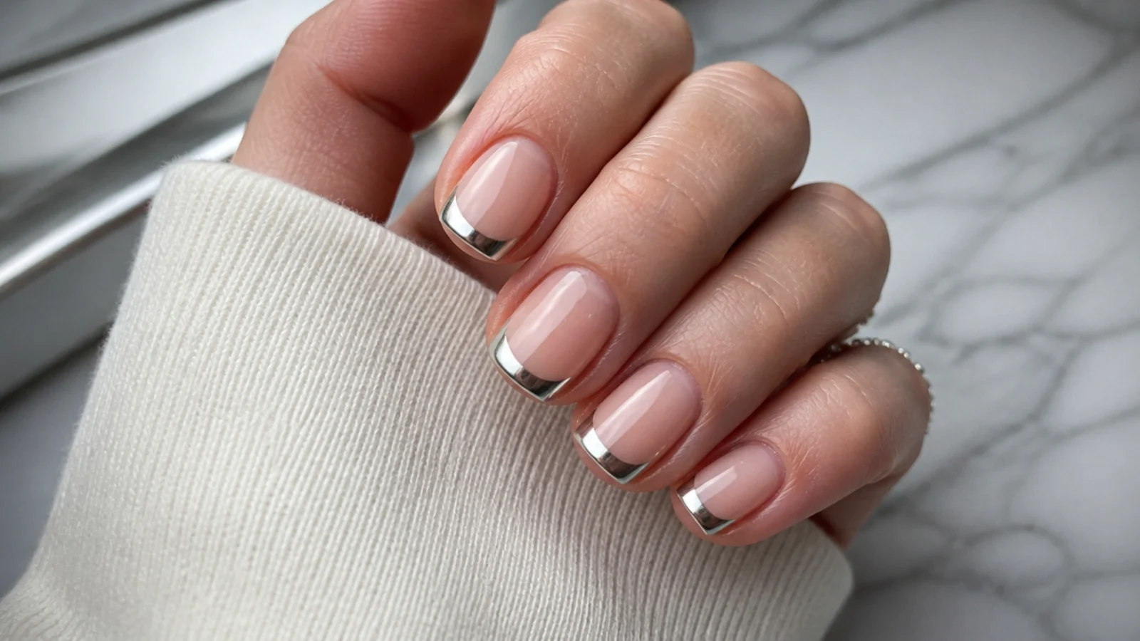 Short square chrome french tip nails with a thin silver light band