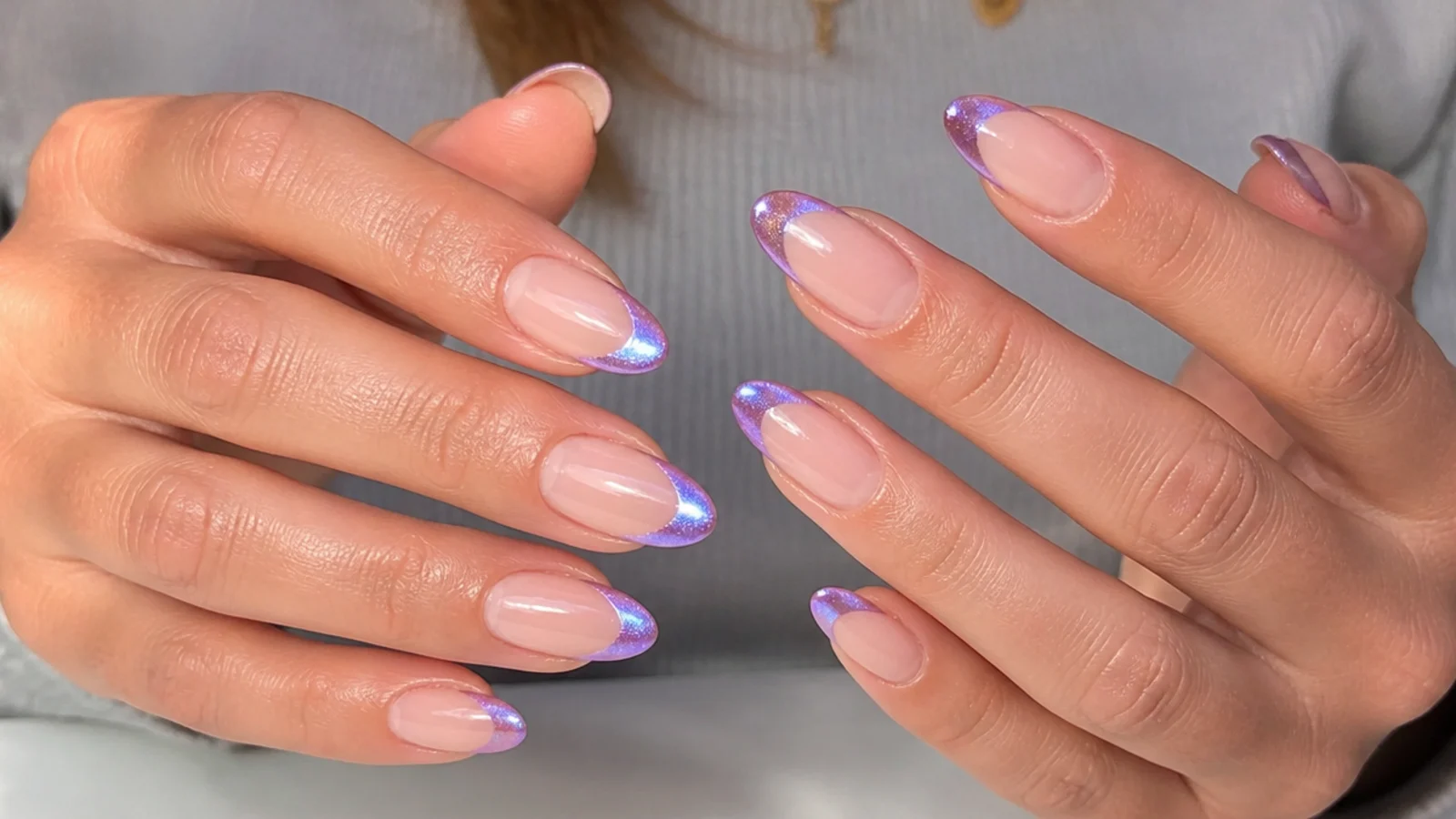 Ten almond nails with matching bright cat eye stripes along each french tip