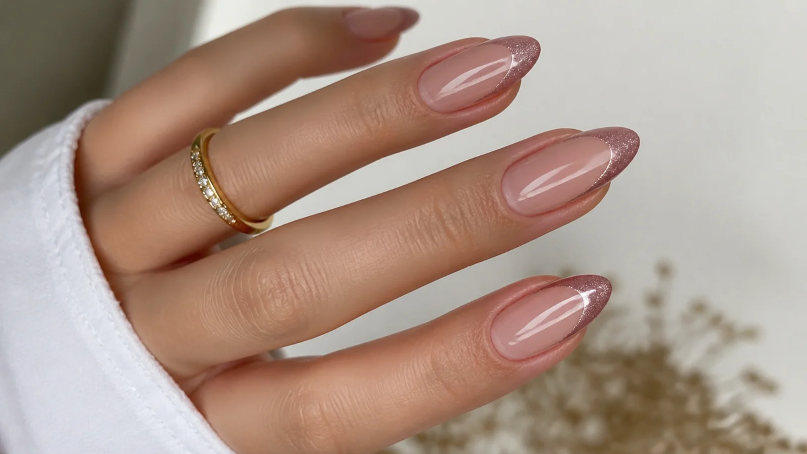 Dusty rose cat eye french tip nails on an almond shape with a soft light stripe