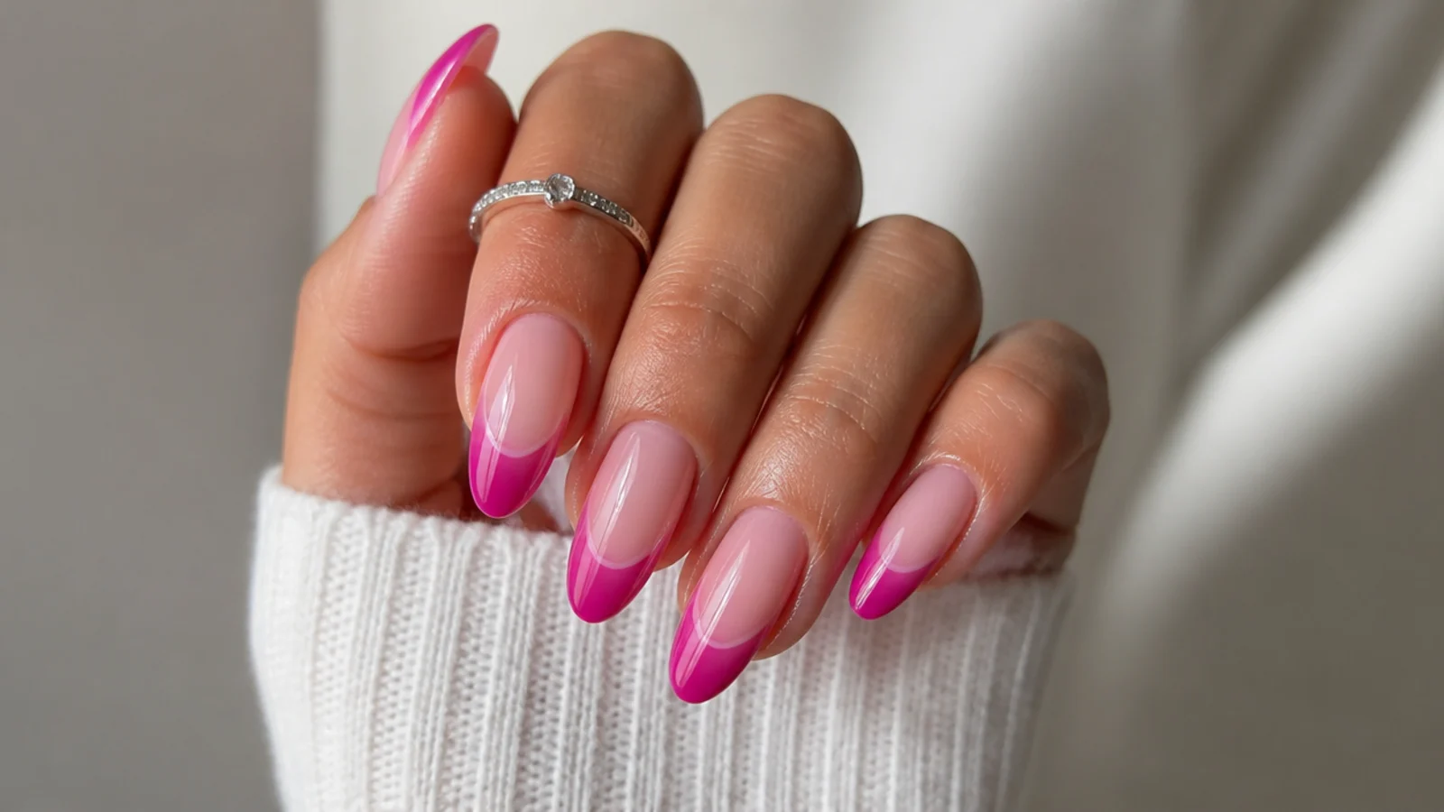 Pink ombre cat eye french tip nails fading from light to deep pink with a light band