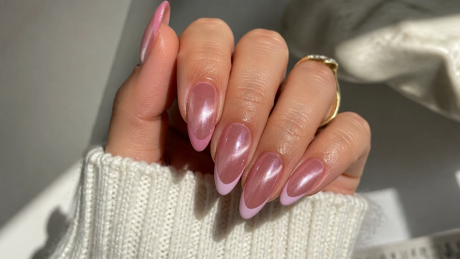 Long almond pink cat eye french tip nails with a dramatic light band