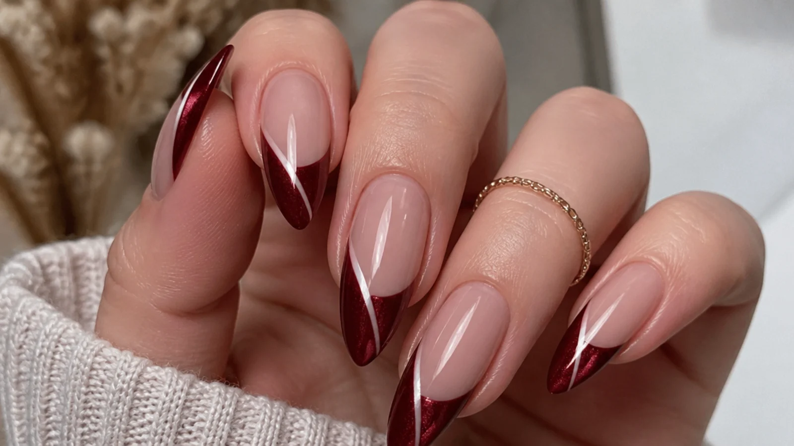 Long almond crimson cat eye french tip nails with a long dramatic light stripe