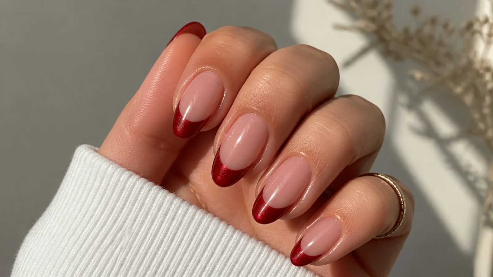 A well-sealed red cat eye french tip manicure with cuticle oil for longevity