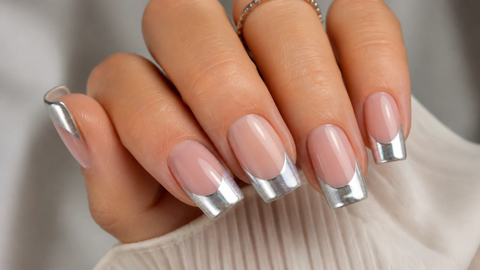 Wide silver chrome cat eye french tip on a square nail with a mirror-like stripe