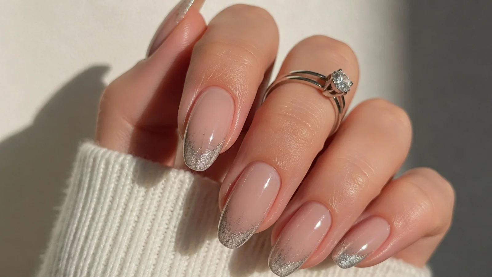 Silver cat eye french tip with fine glitter shimmer on an almond nail