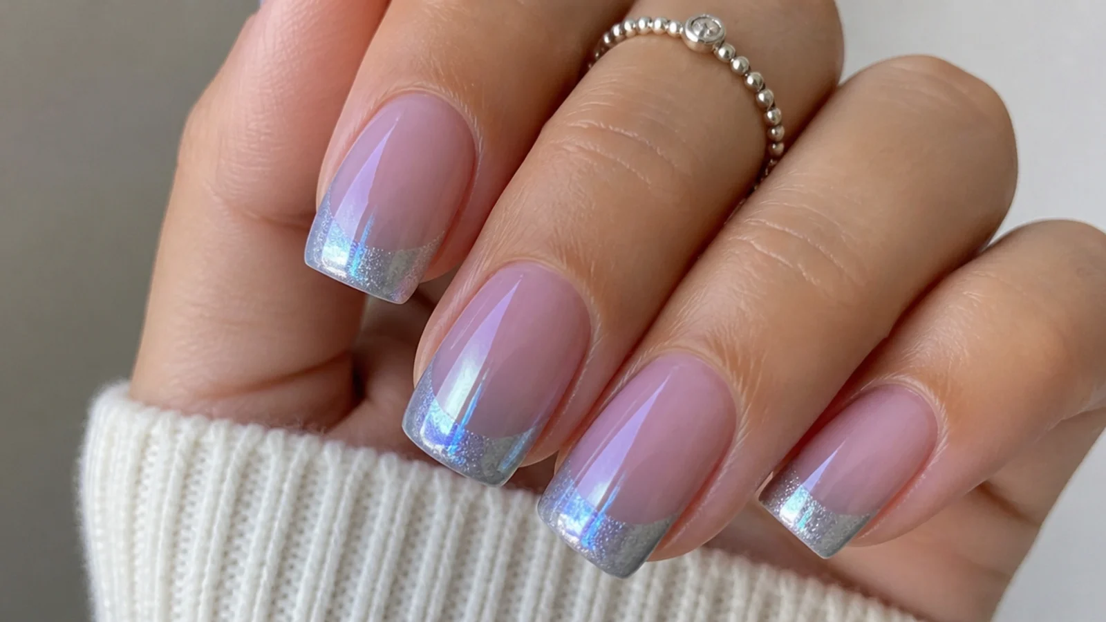 Silver cat eye french tip with a cool blue color shift on square nails