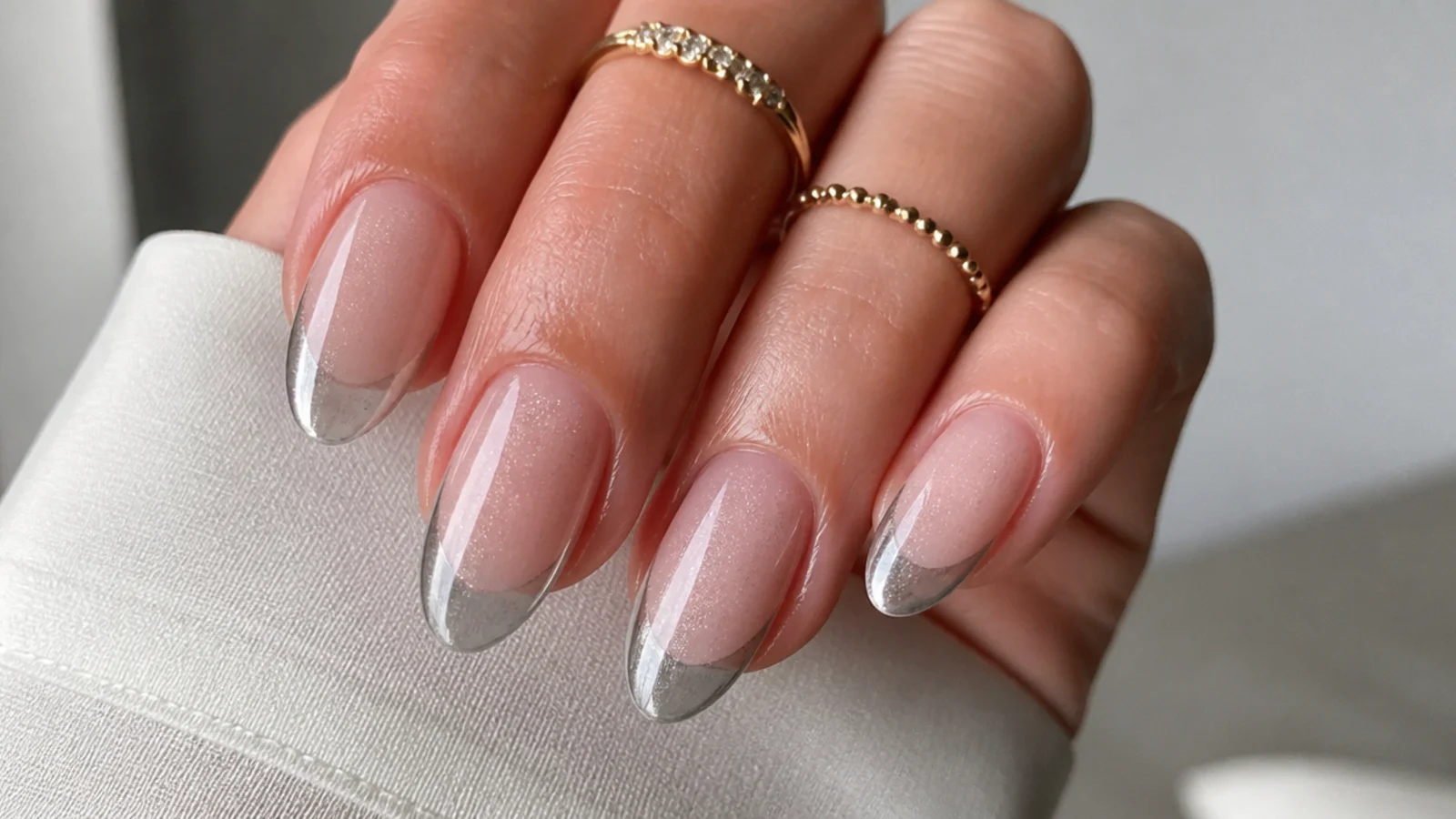 A well-sealed silver cat eye french manicure with cuticle oil for longevity