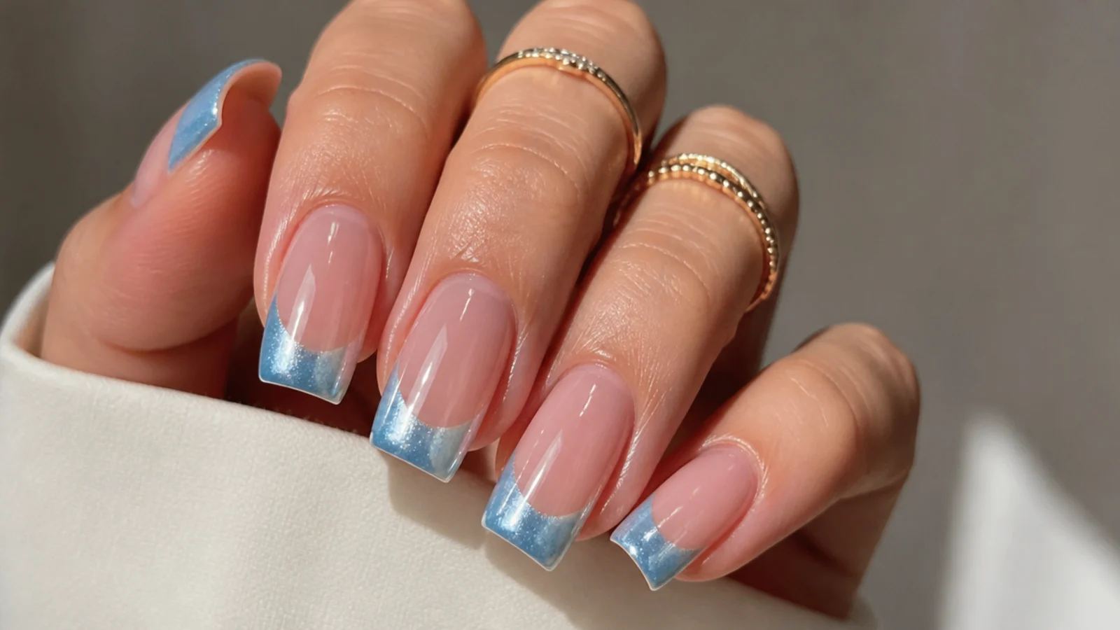 Square nails with an icy blue magnetic cat eye french tip
