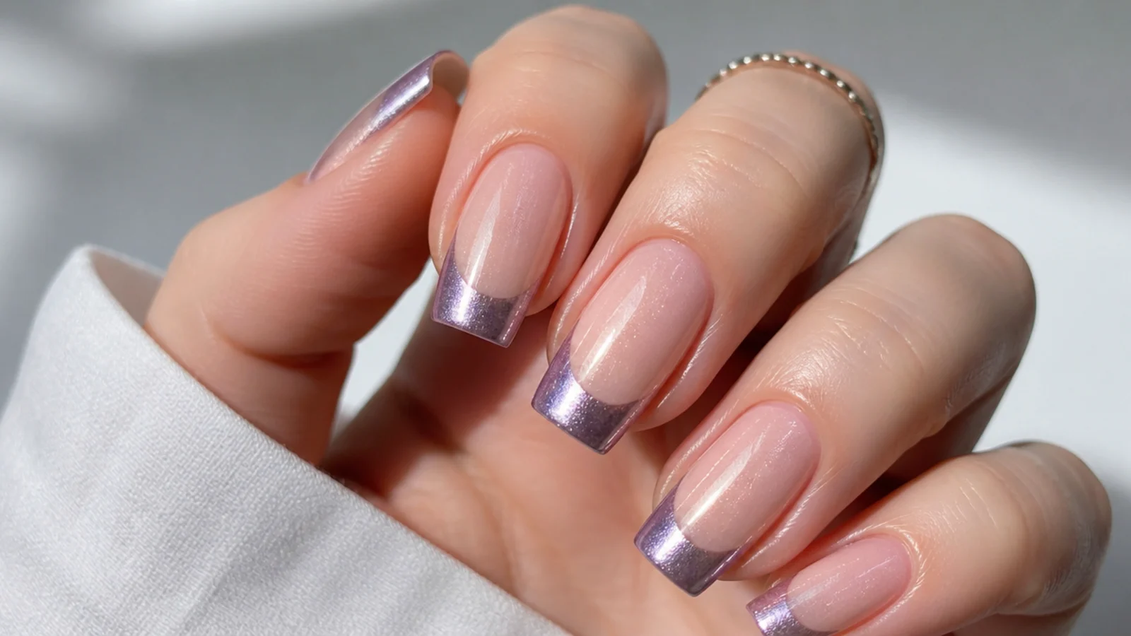 Square nails with a high-shine chrome magnetic cat eye french tip