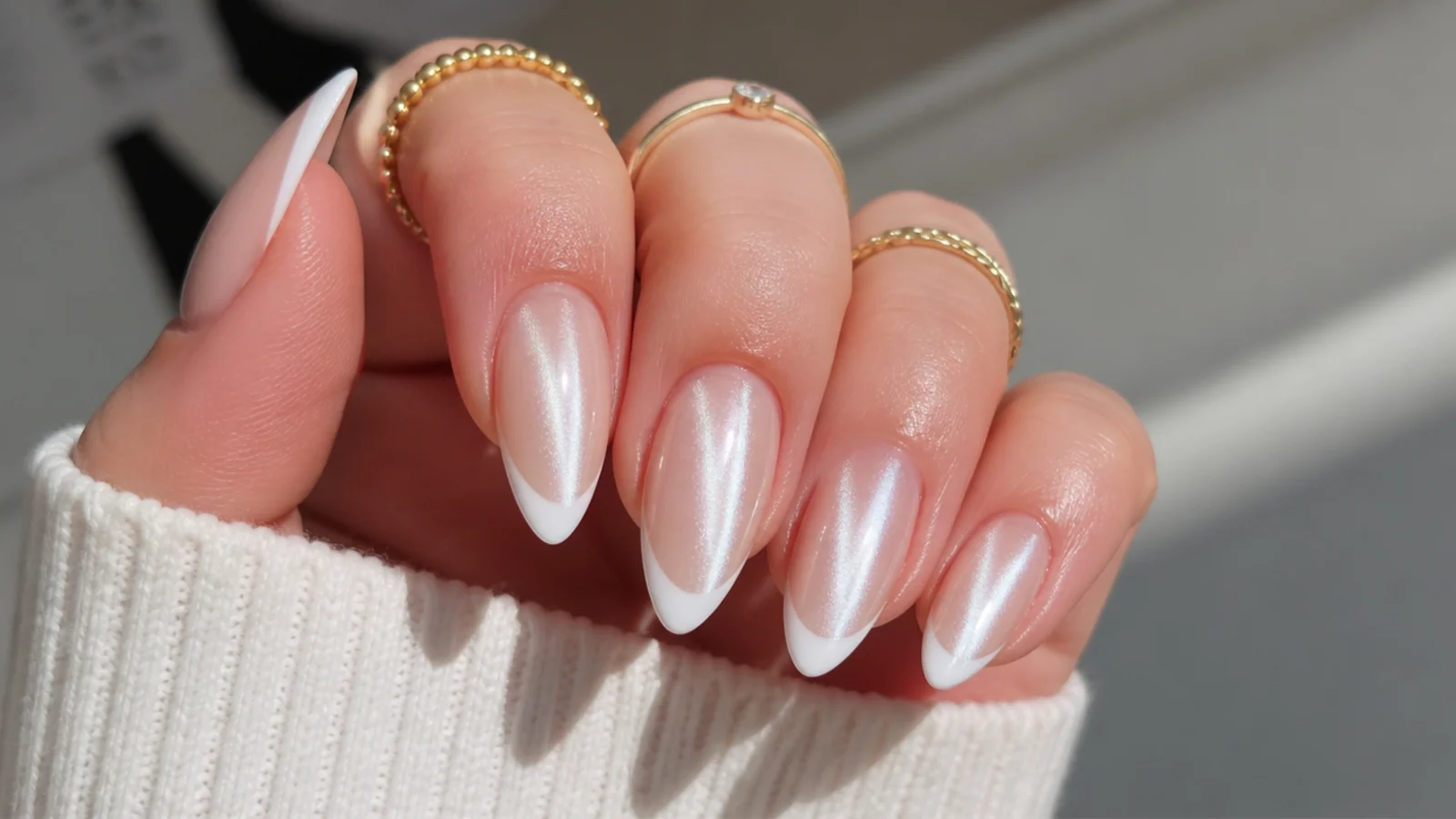 White chrome cat eye french tip nails with a sharp mirror-like light stripe