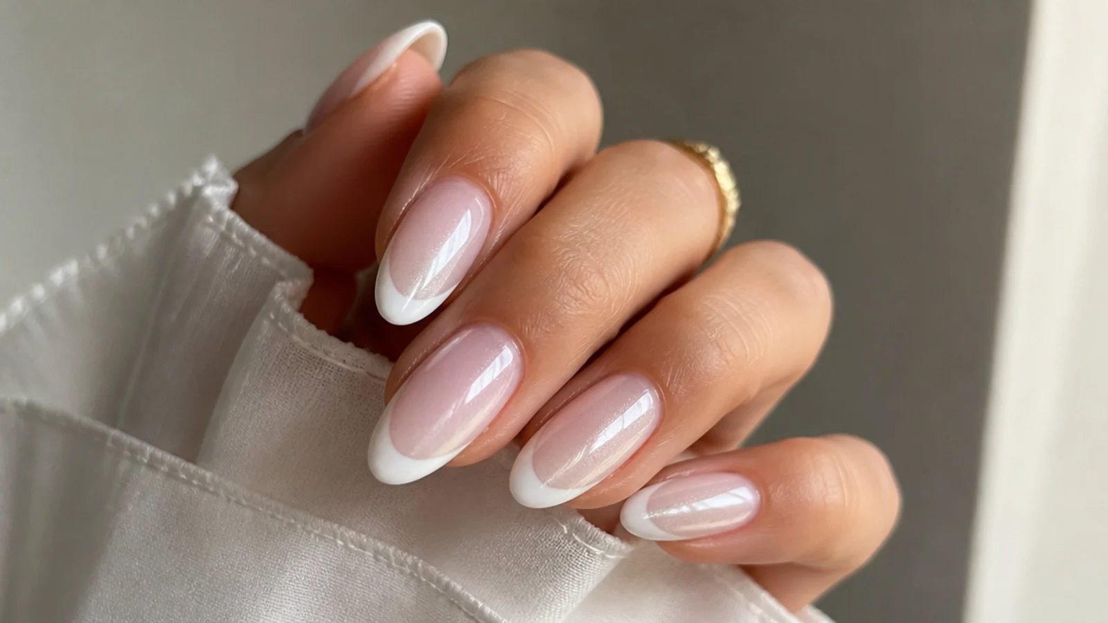 Glazed white cat eye french tip nails with a pearly wet-look light band