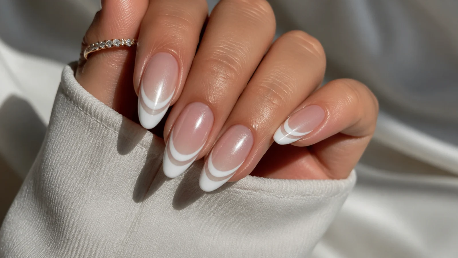 White cat eye french tip nails showing two parallel light bands on the tip